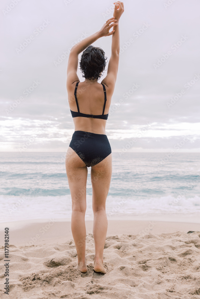 Woman in Swimwear Standing on Coastal Cliff Overlooking Ocean Woman in Swimwear Standing on Coastal Cliff Overlooking Ocean