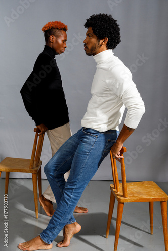 Two men in  turtlenecks side view