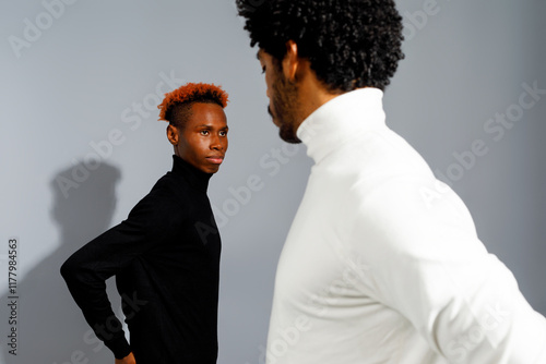 Two men in stylish turtlenecks
