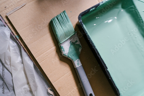 Paintbrush and Green Paint Tray photo