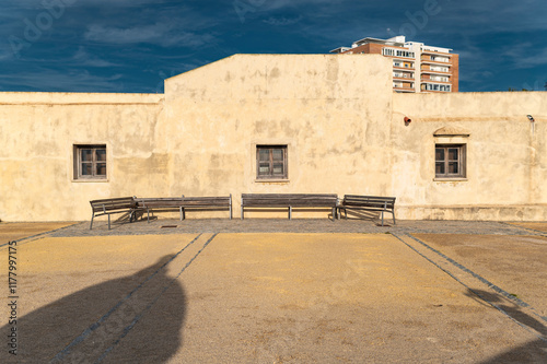 Historic colonial courtyard with benches and stucco wall photo