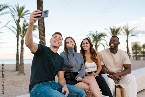 Group of friends taking a selfie on a tropical beach photo