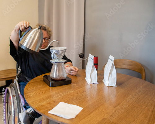 A disabled woman is brewing coffee. photo