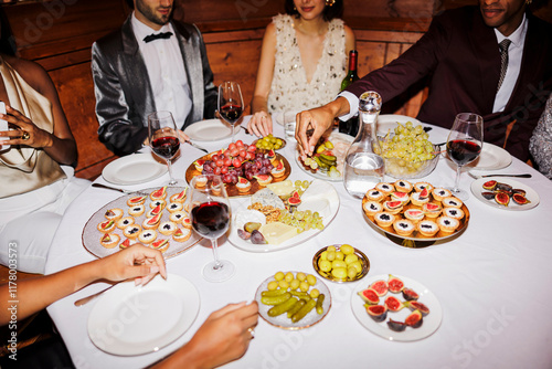 Elegant friends enjoying gourmet appetizers at new year's eve ugc