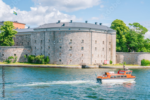 Photography Orange ferry leaving Vaxholm fortress in Stockholm archipelago, Sweden