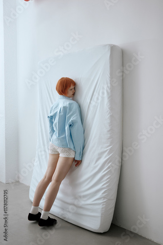 Tired woman lying on mattress