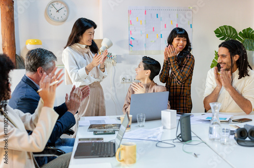 Diverse Business team in work meeting celebrating team achievement 