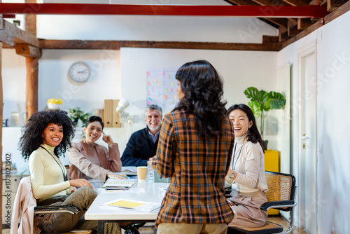 group of coworkers in business meeting talking to project leader