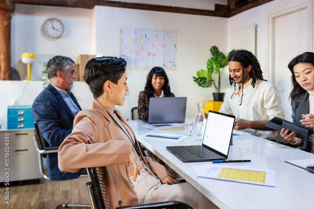 © Jimena Roquero/Stocksy - Group of coworkers in project meeting in office © Jimena Roquero/Stocksy - Group of coworkers in project meeting in office