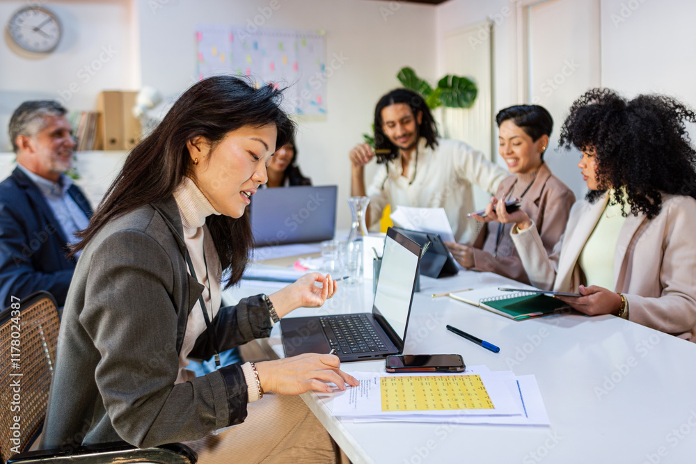 © Jimena Roquero/Stocksy - Modern businesswoman in office meeting discussing strategy © Jimena Roquero/Stocksy - Modern businesswoman in office meeting discussing strategy