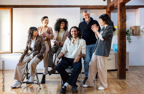 Group portrait of small company team in office posing cheerfully photo