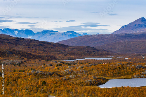 Autumn landscape of Kilpisjarvi, Finland, showcasing colorful foliage, serene lakes, and majestic mountains in the background. photo