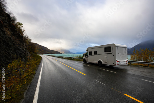 A motorhome parked by the road in the autumn landscape of the Lyngen Alps, Northern Norway, with mountains. photo