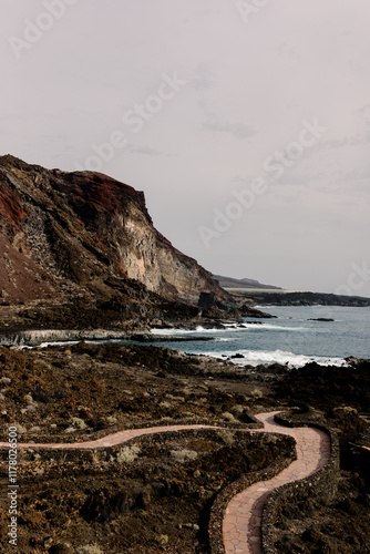 Sweeping perspective of craggy coastal cliffs along Tacorón Beach photo