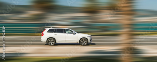 Banner with a fast-moving white car on a speed-blurred background.