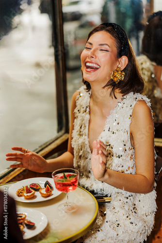 Elegant woman laughing at fancy restaurant ugc photo