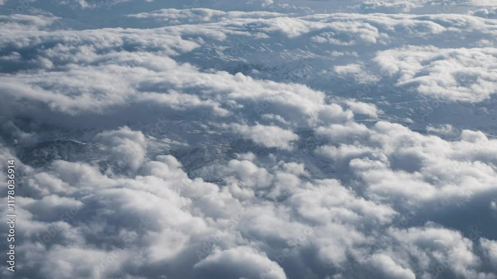 An aerial perspective showcasing soft clouds and a vast sky. Perfect for themes of air travel, serenity, and natural beauty, offering a calm and picturesque view of the atmosphere above. An aerial perspective showcasing soft clouds and a vast sky. Perfect for themes of air travel, serenity, and natural beauty, offering a calm and picturesque view of the atmosphere above.