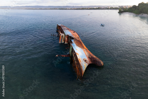 Aerial view of a  partially submerged rusted shipwreck in west java