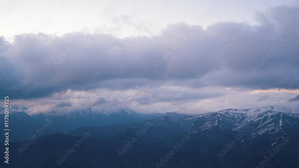 An aerial perspective featuring snow-capped mountains visible through soft clouds. Ideal for themes of exploration, air travel, natural beauty, or serene landscapes. An aerial perspective featuring snow-capped mountains visible through soft clouds. Ideal for themes of exploration, air travel, natural beauty, or serene landscapes.