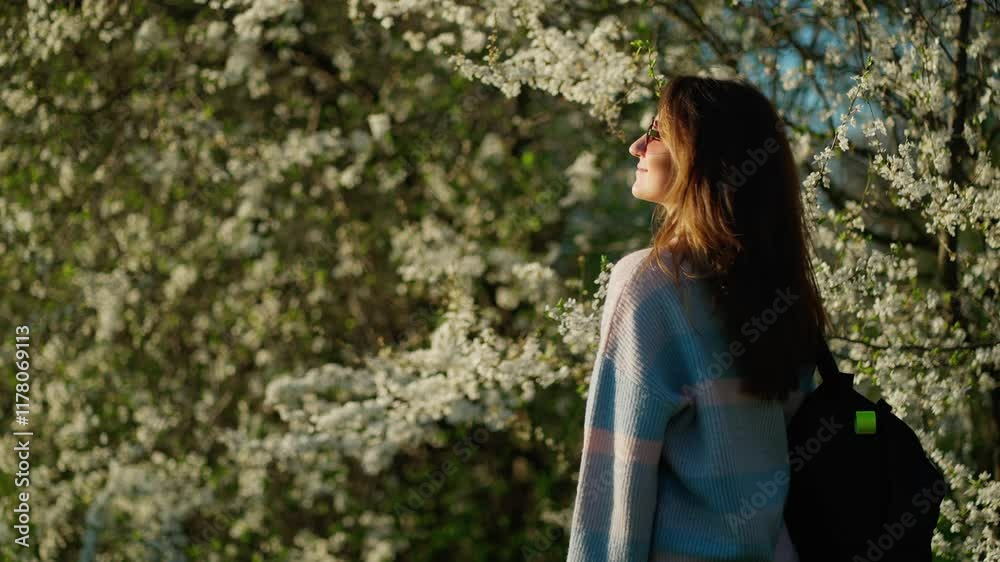 Woman enjoys sunny spring day. Concept of spring walk. Woman enjoys sunny spring day. Concept of spring walk.