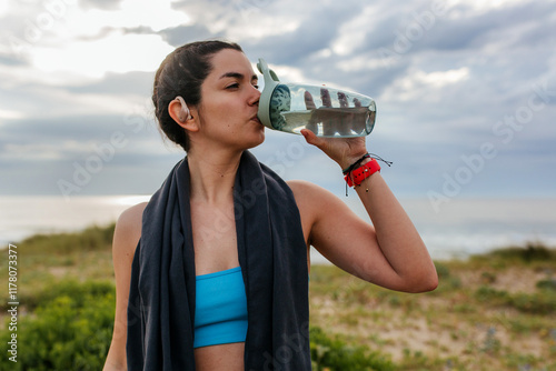 Woman Hydrating after workout photo