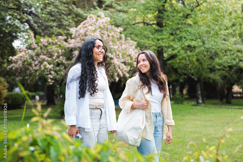 Two Female Friends Walking in a Green Park Two Female Friends Walking in a Green Park