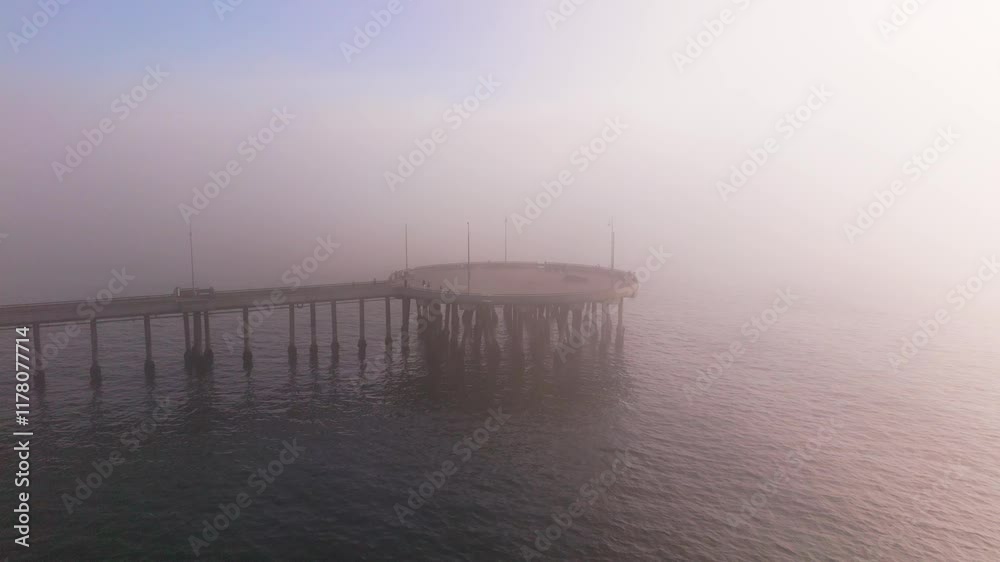A Beautiful Misty Pier Stretching Over the Water at Sunrise, Radiating Peace and Calmness A Beautiful Misty Pier Stretching Over the Water at Sunrise, Radiating Peace and Calmness