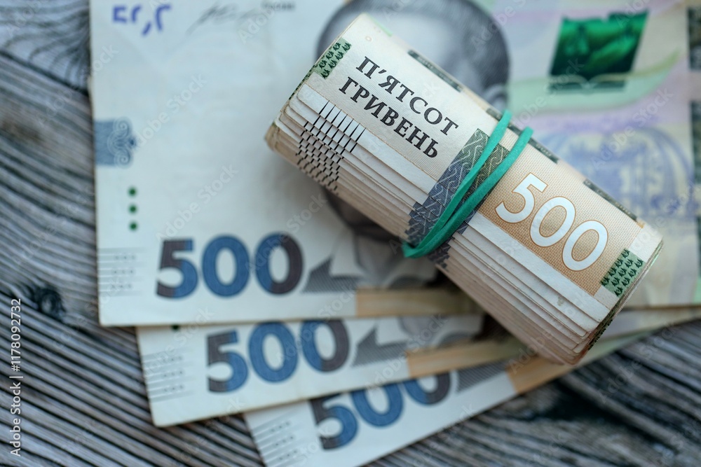 Many five hundred hryvnia money bills lies on wooden background. Ukrainian national currency close up Many five hundred hryvnia money bills lies on wooden background. Ukrainian national currency close up
