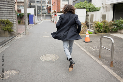 Businessman running in the city photo