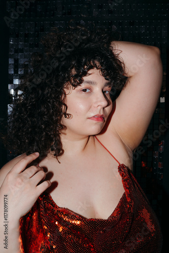 Curly Haired Beauty Shines in Glamorous Setting photo