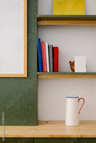 Wooden shelf holding books, pictures and a ceramic decorative jar photo