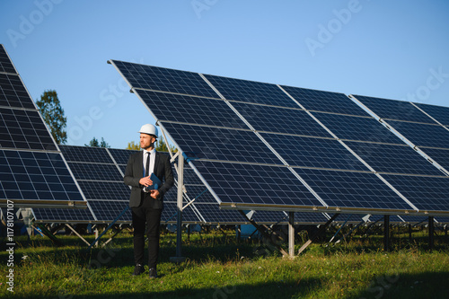 The solar farm, solar panel with engineer check the operation of the system, Alternative energy photo