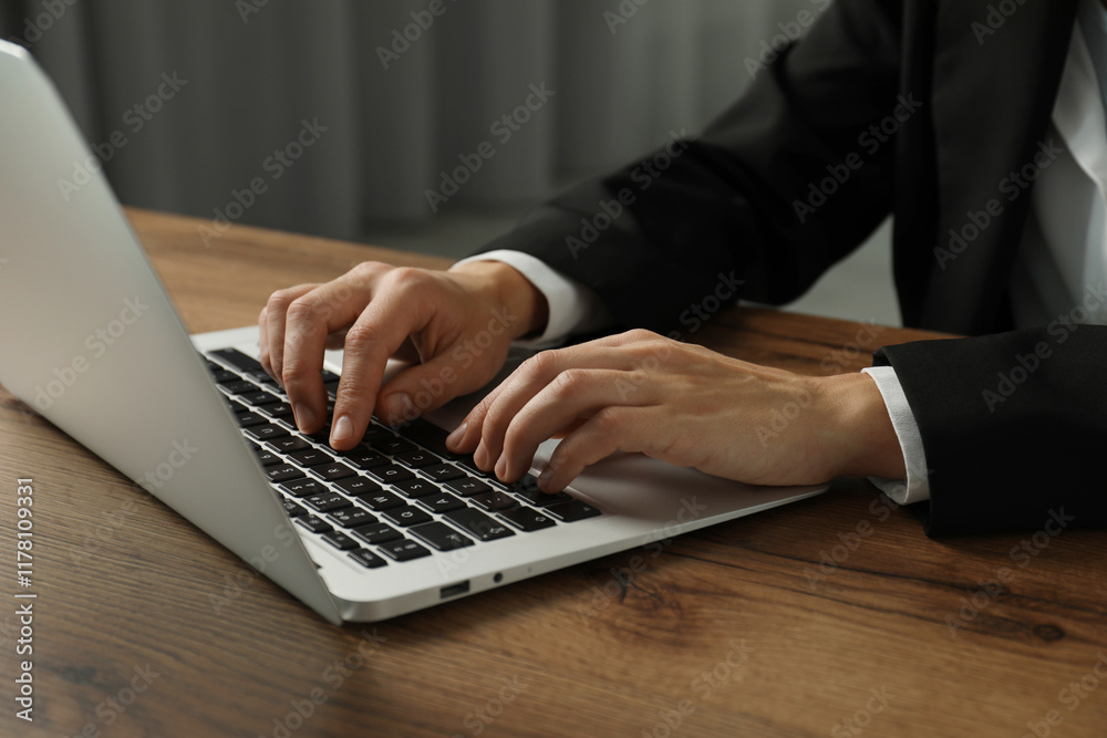 Businesswoman using laptop at wooden table indoors, closeup. Modern technology Businesswoman using laptop at wooden table indoors, closeup. Modern technology