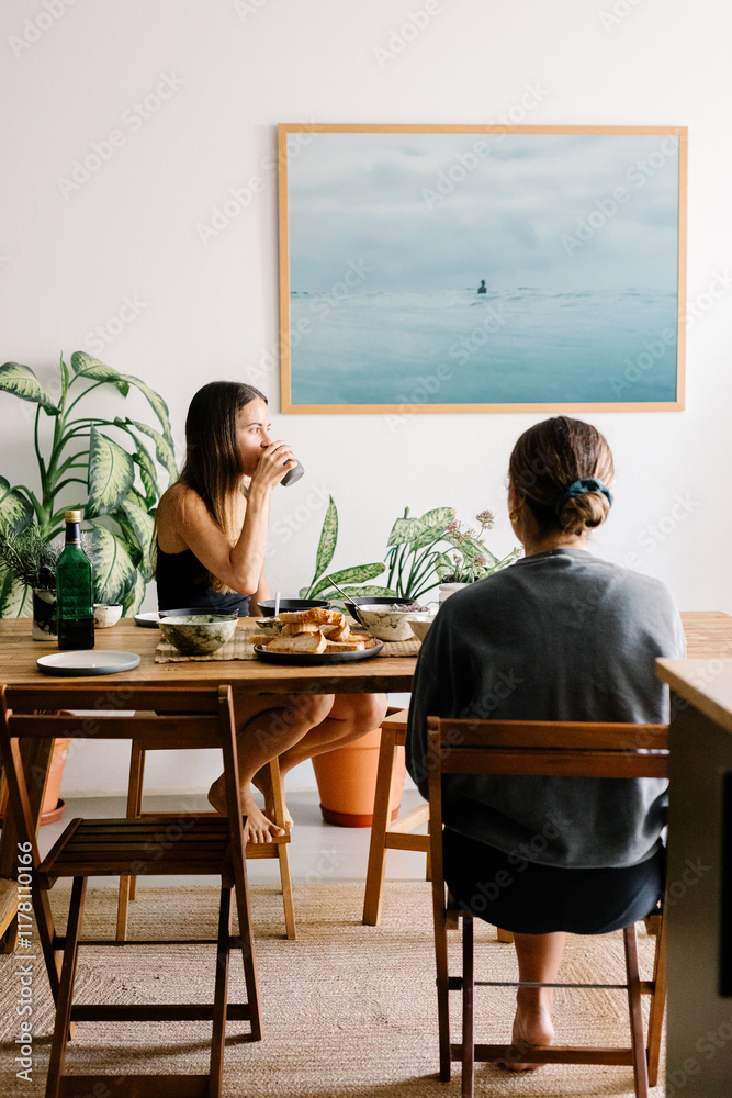 Friends engaged in conversation while enjoying a healthy breakfast Friends engaged in conversation while enjoying a healthy breakfast