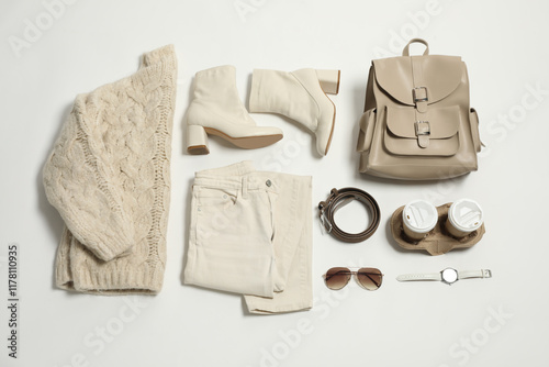 Stylish outfit with backpack on white background, flat lay photo