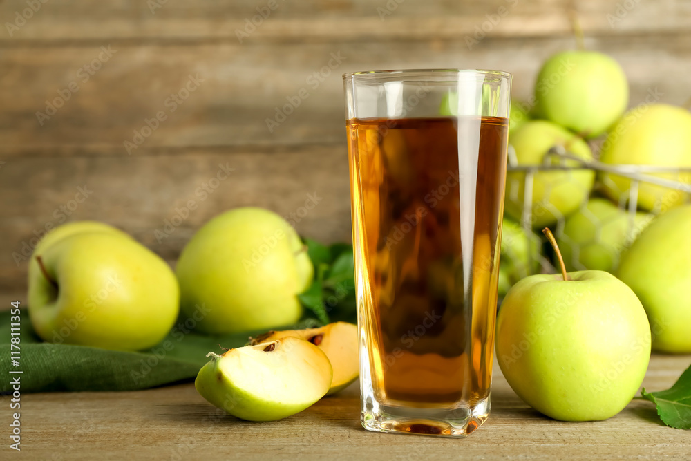 Glass of juice and apples on wooden table Glass of juice and apples on wooden table
