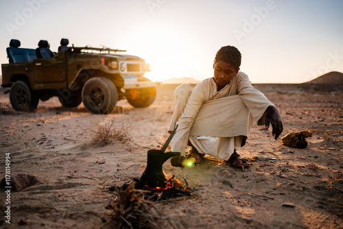 young bedouin cooking tea photo