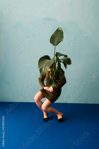 Unique Conceptual Photography of Person Holding Large Plant photo