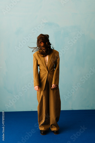 Fashion Portrait Of Person In Oversized Suit With Whimsical Hair photo