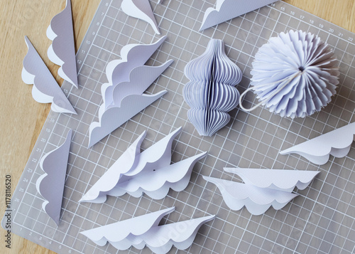 Diy paper ornaments in various design scattered on crafting mat photo