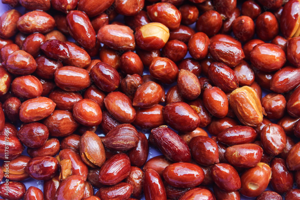 texture and blackish brown background of fried peanuts close up texture and blackish brown background of fried peanuts close up