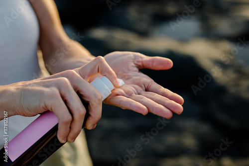 Woman's hands applying a dermatological moisturizing product photo