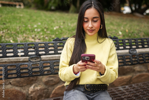 generation z woman using mobile phone outdoors photo