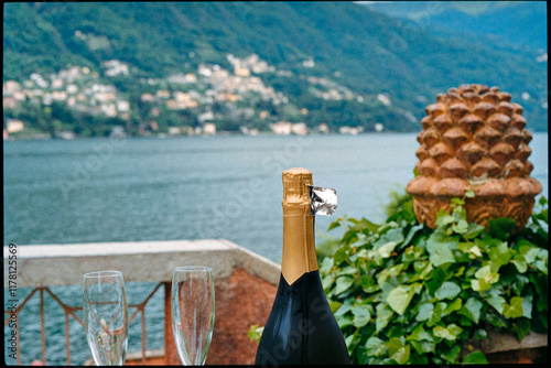 A bottle of sparkling wine with a view of Lake Como in Italy photo