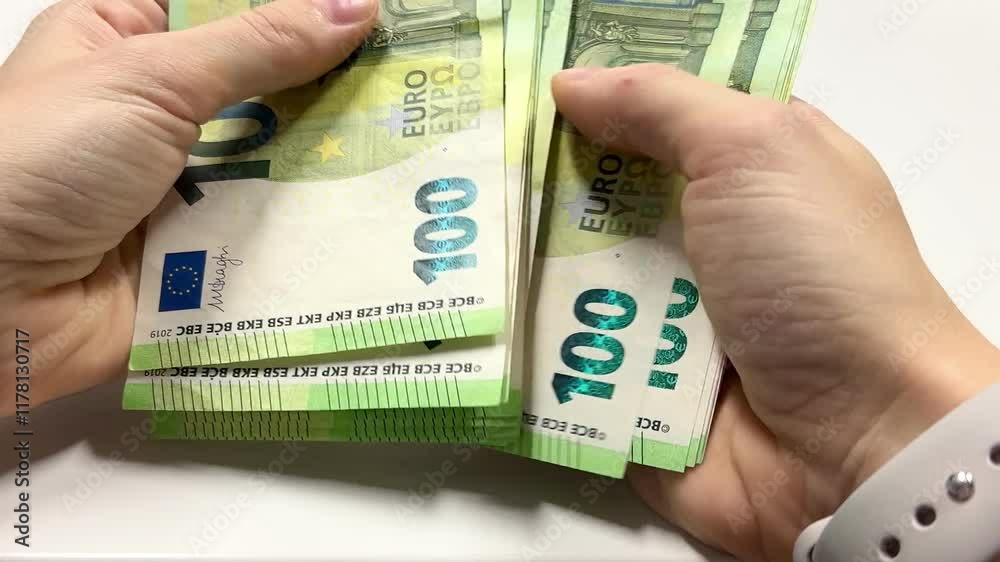 Counting euro banknotes. Female hands count 100 euros cash. Investments, family budget and savings concept