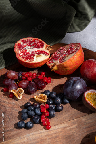 Still Life of Vibrant Fresh and Dried Fruits on Wooden Board photo