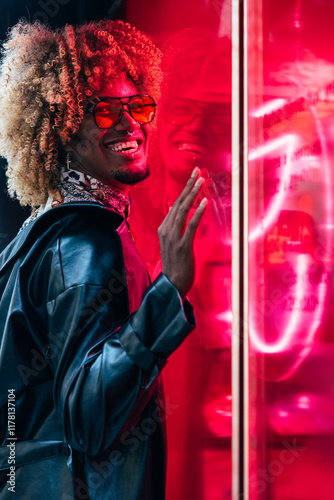 Gay Man Smiling in Neon Glow with Reflective Urban Style photo