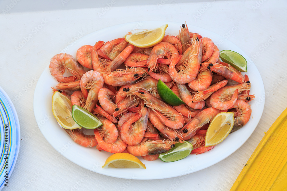 A plate of Spencer Gulf prawns with lemon and lime slices. Australia. A plate of Spencer Gulf prawns with lemon and lime slices. Australia.