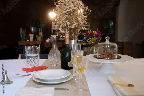 Home with Christmas table with champagne in a dark background photo