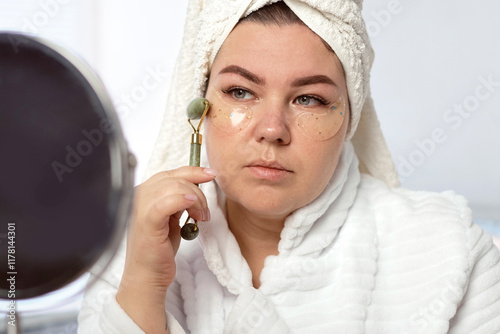 Woman using face roller photo